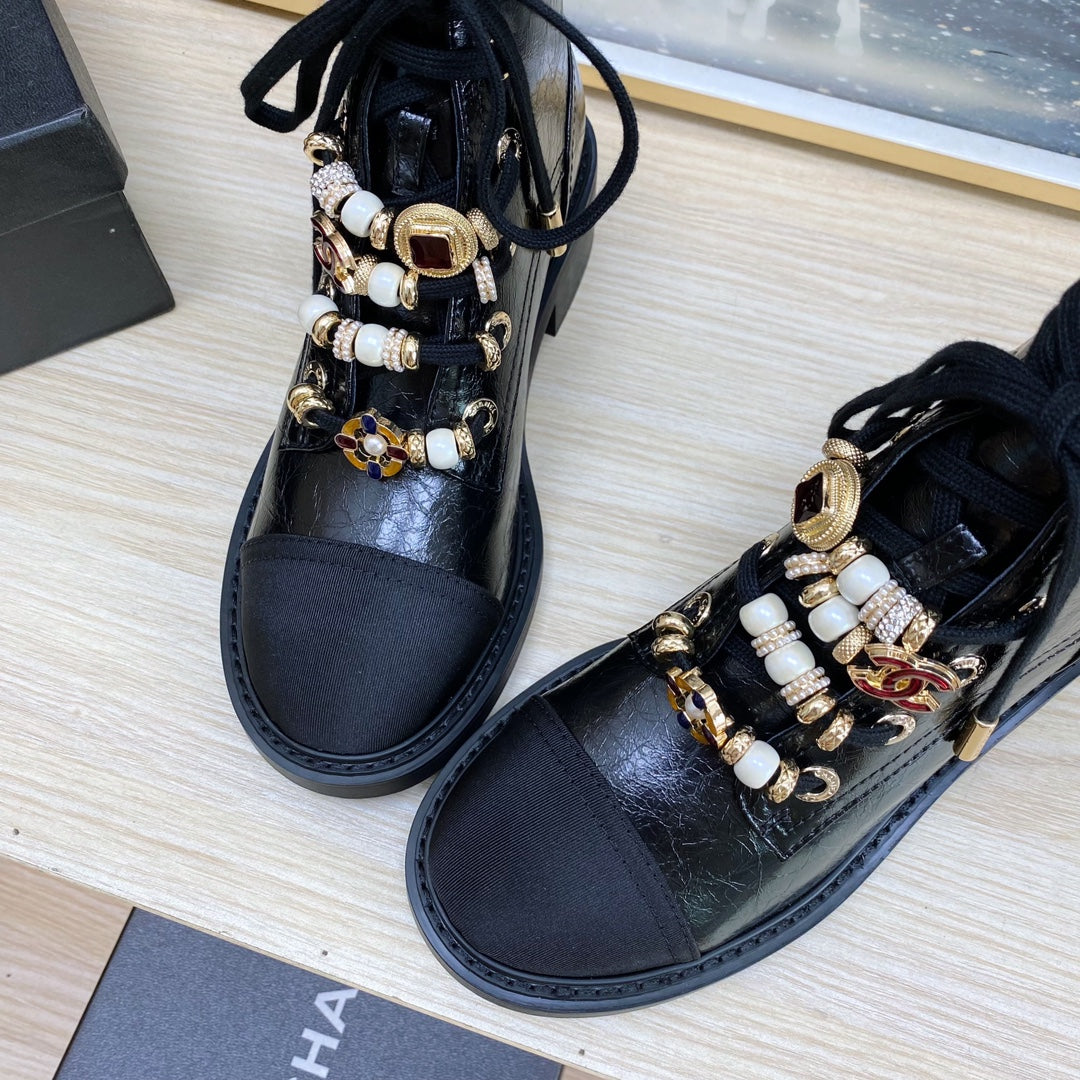 CHANEL COMBAT BOOTS IN BLACK WRINKLED CALFSKIN AND GROSGRAIN WITH FAUX PEARL